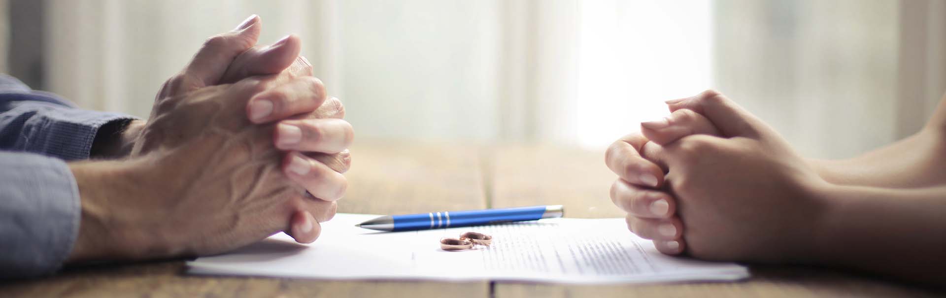 couple signing paperwork for financial planning after divorce